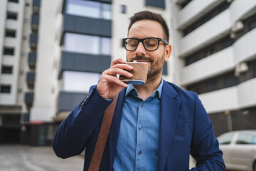 Adult man businessman drink alcohol from flask while go to work