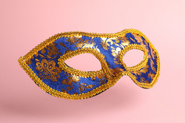 Beautiful bright carnival mask on pink background