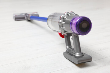 One cordless vacuum cleaner on wooden floor indoors, closeup
