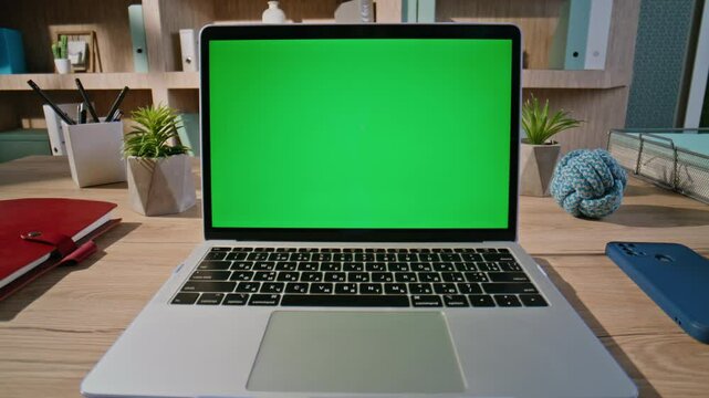 Hands pressing keyboard chroma key laptop at office desk closeup. Unknown man
