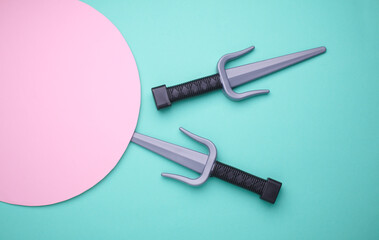 Children plastic toy ninja weapon on blue background. Top view