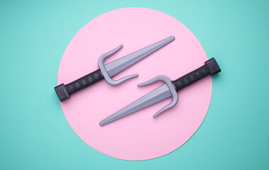 Children plastic toy ninja weapon on blue background. Top view © splitov27