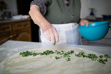 Senior woman making pie at home