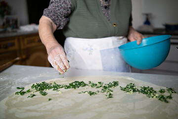 Senior woman making pie at home
