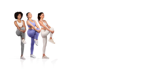 Three women in athletic wear are engaging in dynamic leg stretches, highlighting fitness and teamwork in a bright studio setting, promoting health and exercise awareness.