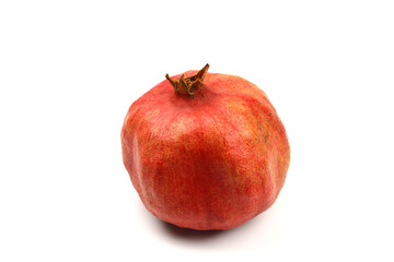 Ripe pomegranate fruit peeled on a white background top view close-up. Large open pomegranate fruit with large ripe grains isolated. Sliced exotic fruit.