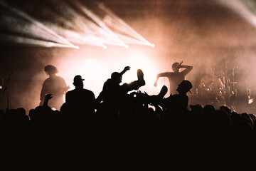 Crowd of people crowd surfing at a rock concert