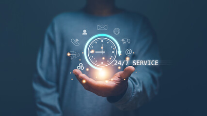 Full time available contact of service concept. Businessman holding virtual clock with text 24 -7 Service and customer service icon. Assistance customer service. Customer call contact in any time.