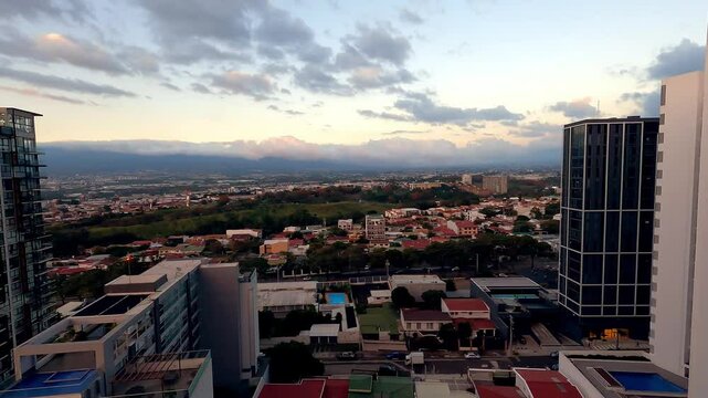 Time lapse view of San Jose Costa Rica at sunset with cars traveling through city