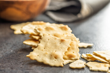 A crispy salted crackers on black table.