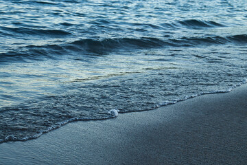 Water over sand on a beach in Athens, Georgia on an autumn afternoon.