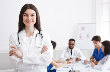 Fototapeta premium Love My Job. Happy Practitioner At Medical Conference Smiling To Camera In Meeting Room, Empty Space