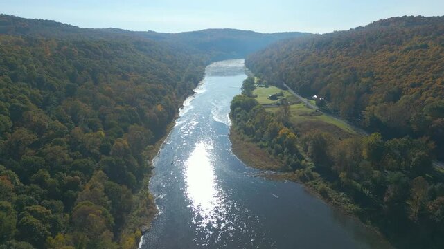 Aerial view of a colorful Autumn valley with a calm a river, drone 4K