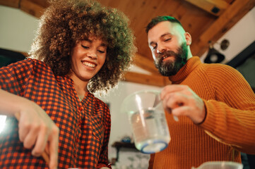 Happy couple cooking together in modern kitchen