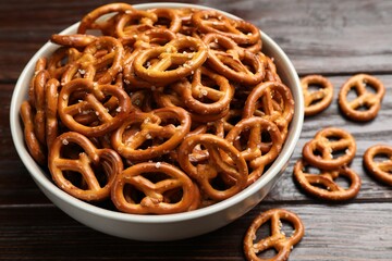 Tasty pretzel crackers on wooden table, closeup