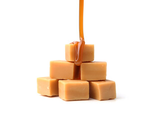 Caramel sauce dripping onto candies on white background, closeup