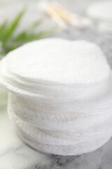 Cotton pads on light marble table, closeup
