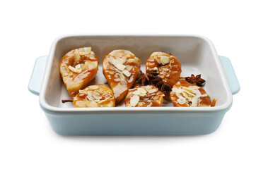 Delicious pears with caramel sauce, almond flakes and anise stars in baking dish isolated on white