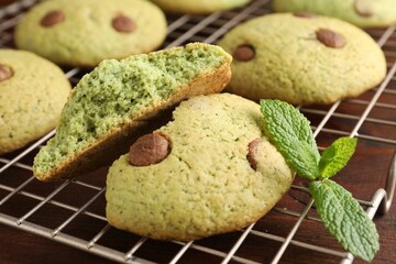 Delicious mint chocolate chip cookies on wooden table, closeup