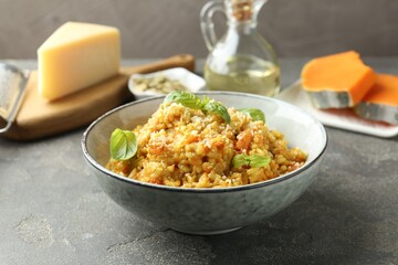 Delicious pumpkin risotto on grey table, closeup