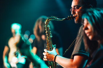 Saxophonist performing live with band on stage