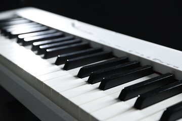 Naklejka premium Synthesizer on black background, closeup. Electronic musical instrument
