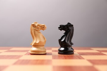 Black and white chess pawns in middle of chessboard. Competition concept