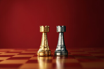 Golden and silver chess rooks in middle of chessboard. Competition concept