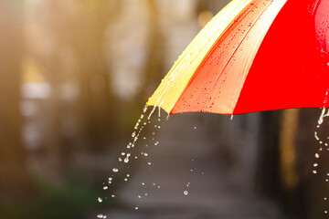 Open bright umbrella under pouring rain outdoors, closeup