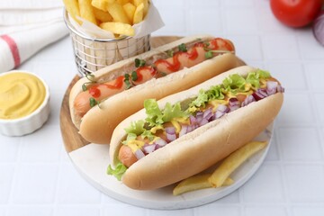Tasty hot dogs served on white tiled table, closeup