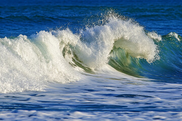 Fototapeta premium Ocean wave foam texture, dynamic white froth over deep blue water, capturing motion and energy