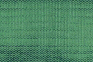 Plain green jacquard upholstery fabric, satin material with woven structure, pattern texture background. Close up, macro cloth textile surface. Wallpaper, backdrop with copy space