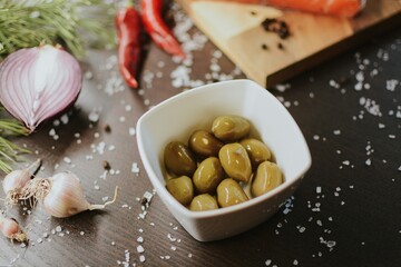 Fresh red salmon on wooden tray with pepper, salt, garlic, red onion, red pepper, olives with jam