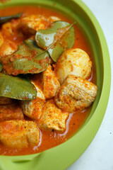 Eggs and tofu balado with spices and lime leaves. Indonesian cuisine. Focus selected