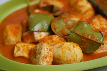 Eggs and tofu balado with spices and lime leaves. Indonesian cuisine. Focus selected