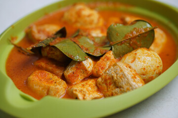Eggs and tofu balado with spices and lime leaves. Indonesian cuisine. Focus selected