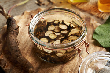 Preparation of herbal tincture from fresh wild burdock root and alcohol