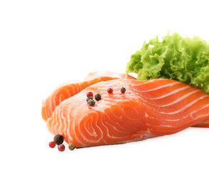 Pieces of fresh salmon, peppercorns and lettuce isolated on white