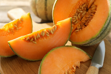 Cut ripe Cantaloupe melon and knife on table, closeup