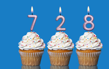 Birthday Cupcakes With Candles Lit Forming The Number 728