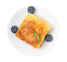 Slice of tasty semolina cake and blueberries isolated on white, top view