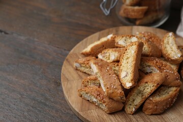 Traditional Italian almond biscuits (Cantucci) on wooden table, closeup. Space for text