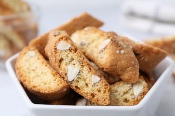 Traditional Italian almond biscuits (Cantucci) in bowl on table, closeup