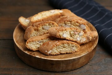 Tasty almond biscuits (Cantuccini) on wooden table, closeup