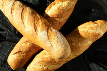Freshly baked baguettes on table, top view