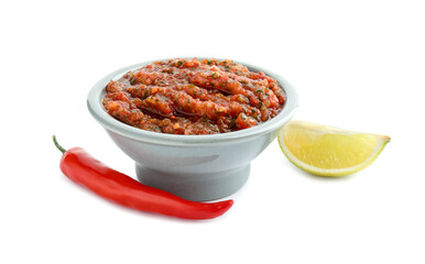 Tasty salsa sauce in bowl, lime and chili pepper isolated on white