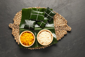 Cut banana leaves with rice on dark table, top view. Healthy eco serving