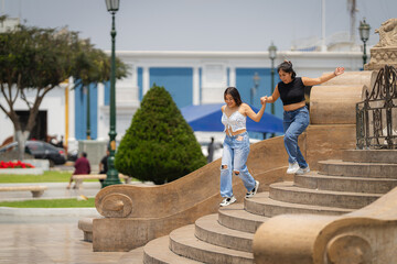 Two friends walking down the stairs in trujillo, peru