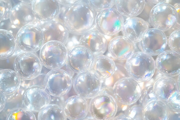 Transparent bubble texture, iridescent spheres with light rainbow reflections against a blurred background