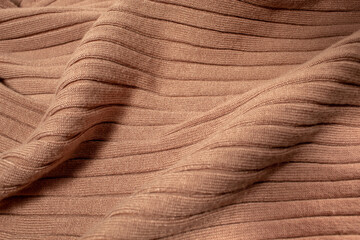 Texture of brown knitted sweater. Background